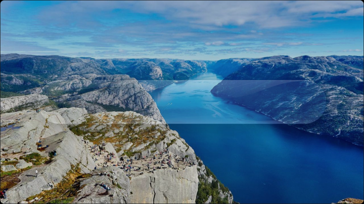 A channel bar of clear glass over a photograph of a fjord, the water and cliffs visibly magnified through it